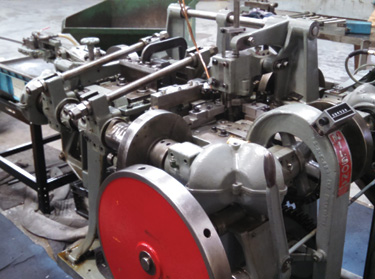 Four-slide and press equipment for formed metal component production